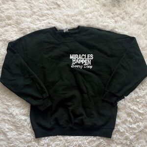 dark green “miracles happen everyday” crewneck